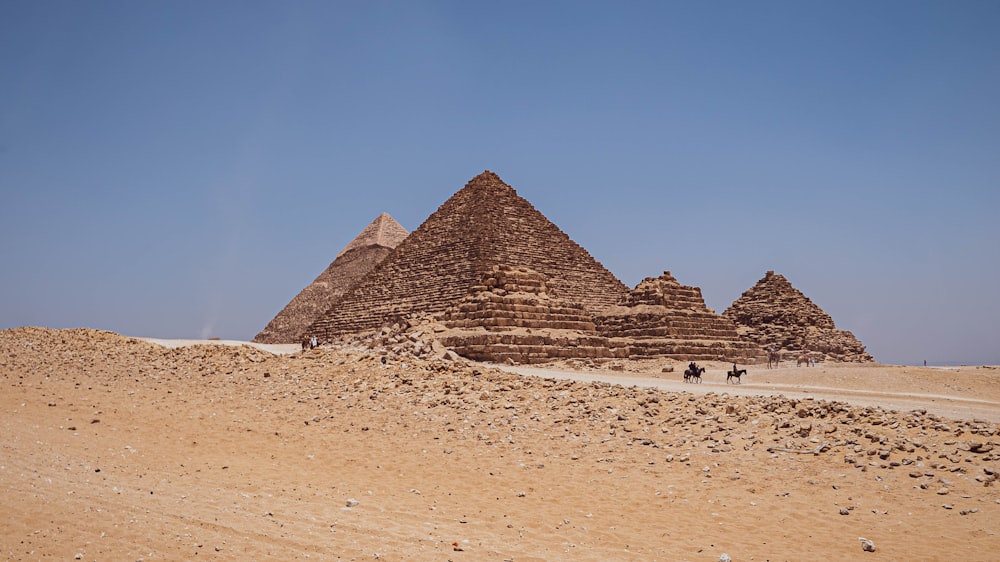 a group of pyramids in a desert