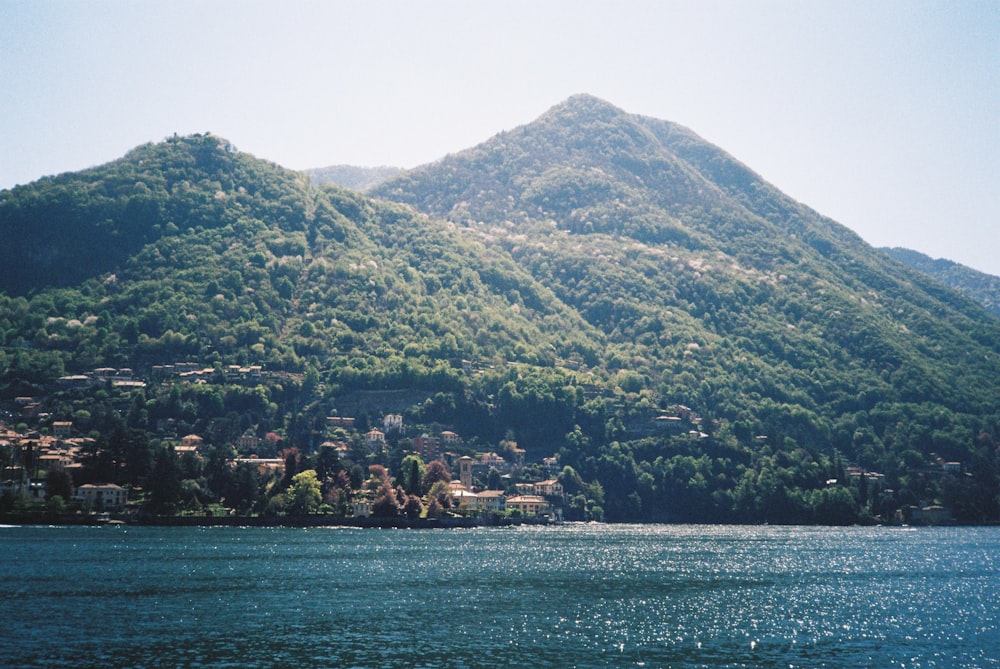 a body of water with a mountain in the background