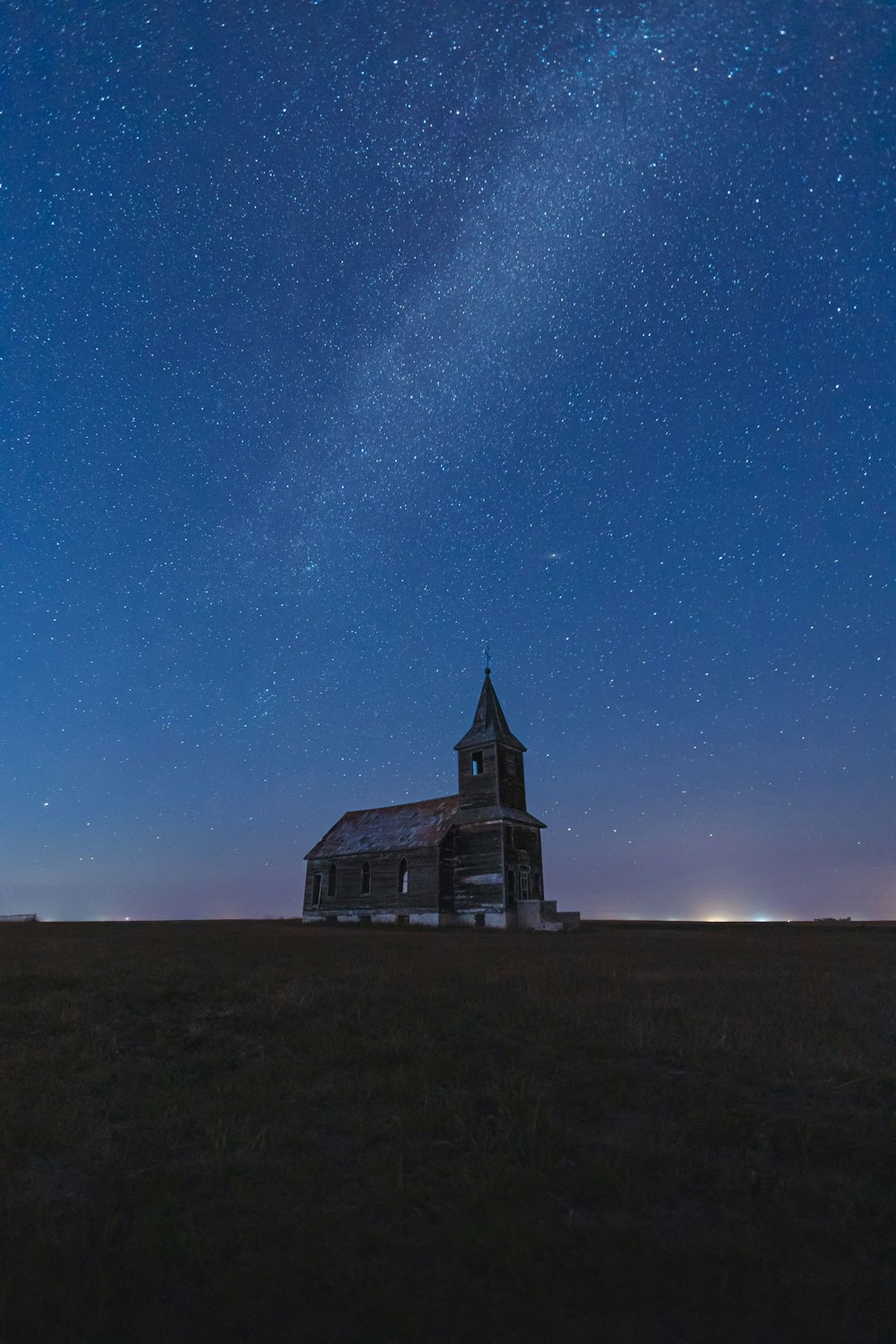 a building with a tower and a starry sky above