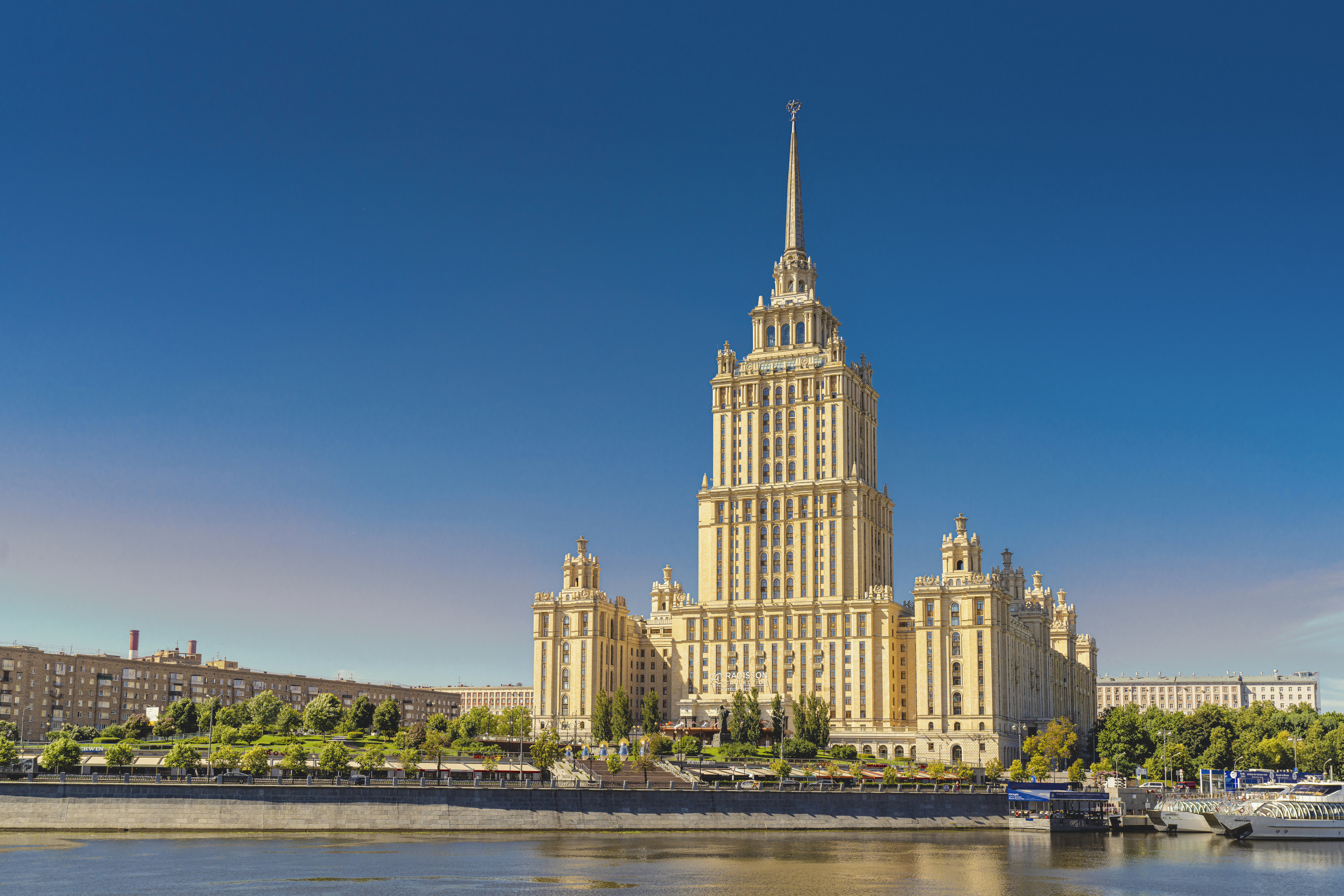 a large building with a pointy tower by a body of water