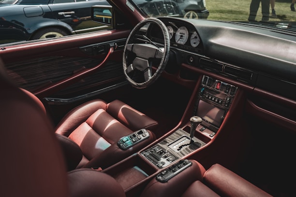 a person holding a cell phone in a car