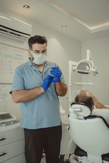 a man in a mask and gloves standing next to a man in a toilet