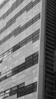 Before and after shots of a commercial building’s glass facade.