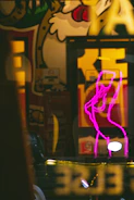Close-up of a graphic artist creating retro-inspired street art with neon colors and cassette tape motifs