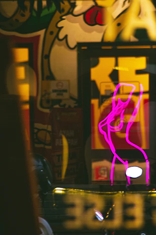 A vibrant street art mural featuring popular Brazilian pop culture icons with neon colors.