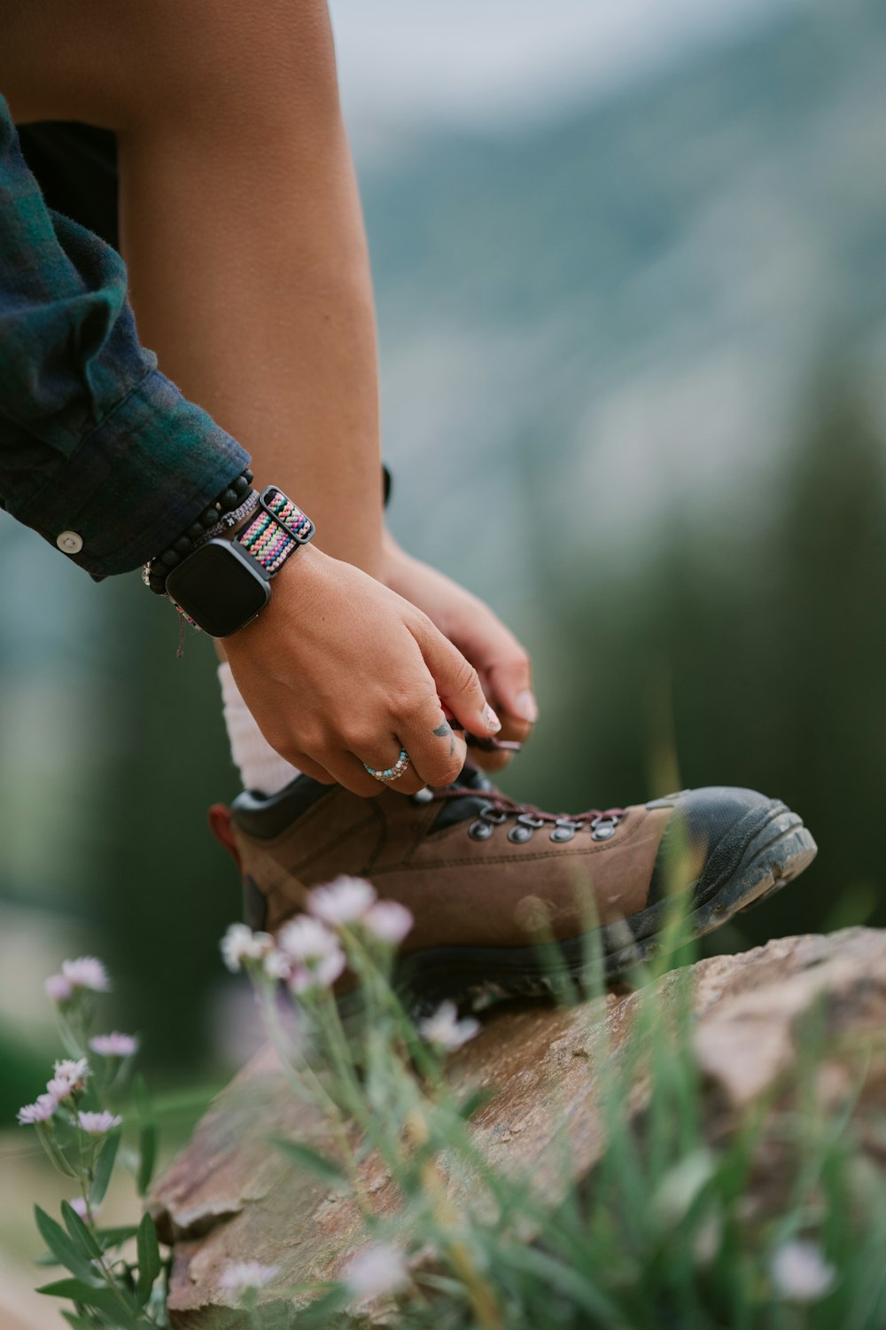 a person's hands holding a shoe