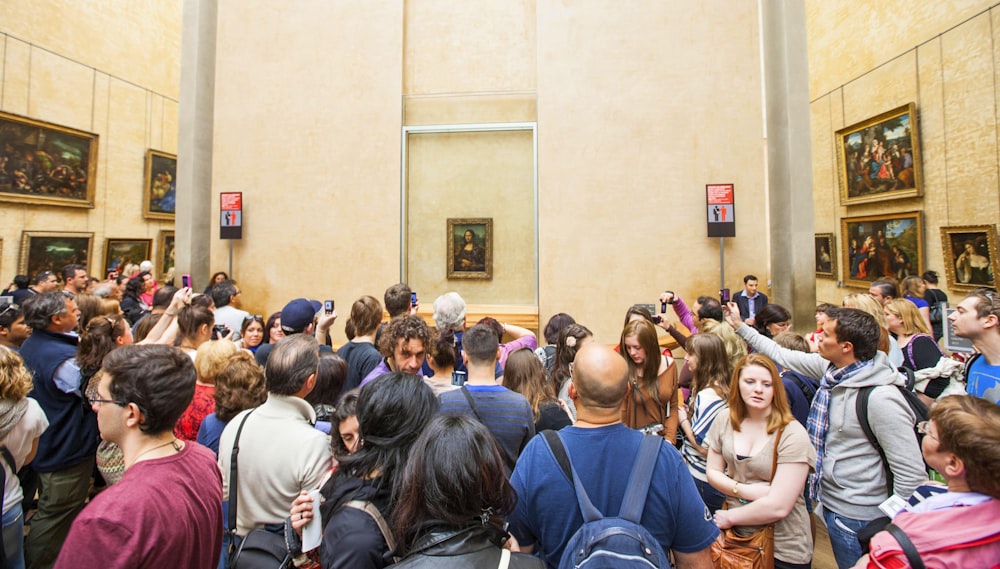 a large group of people in a museum