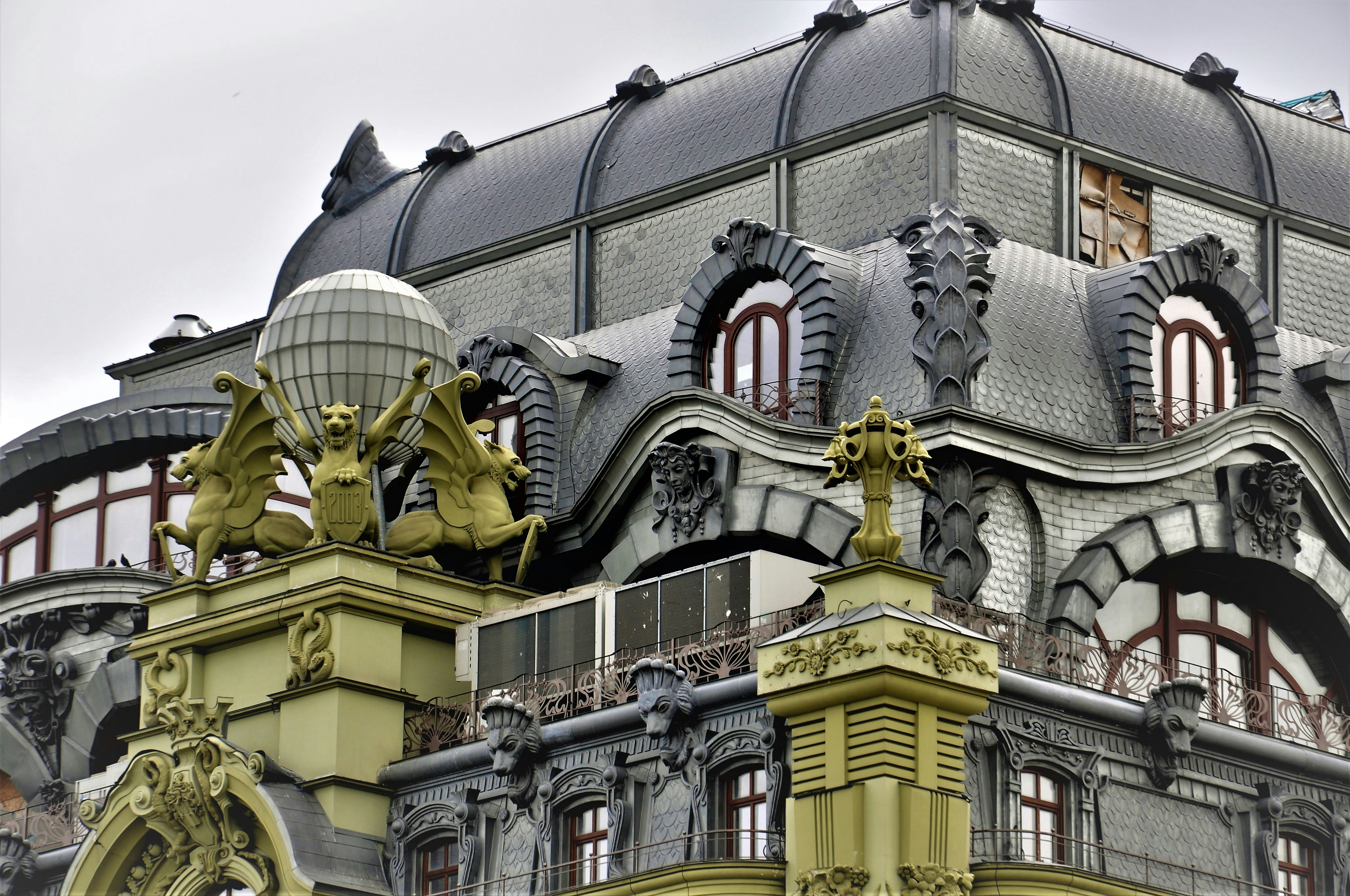 a building with a gold statue in front of it
