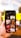 A hand holding a smartphone displaying various images related to religion. The images include crosses, candles, a person meditating, and architectural structures. The background is blurred with bright yellow lights.