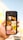 A hand holds a smartphone displaying a search result for animals. The screen shows a grid of nine images, featuring various animals including a parrot, cat, bird, and lion.