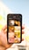 A hand holds a smartphone displaying a search result for animals. The screen shows a grid of nine images, featuring various animals including a parrot, cat, bird, and lion.