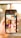 A person holds a smartphone displaying a search screen with the word 'Beauty' and a grid of various images. The images appear to showcase different aspects of beauty, such as portraits of women, close-ups, and artistic visuals. The background is blurred with warm lighting, suggesting an indoor or outdoor setting with sunlight.