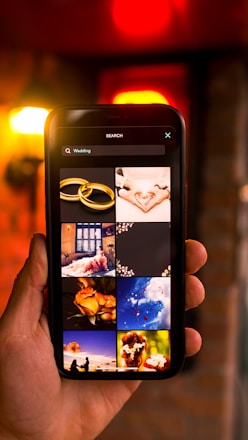 Close-up of a smartphone screen displaying a vibrant, personalized wedding invitation video from shadiinvite.in.