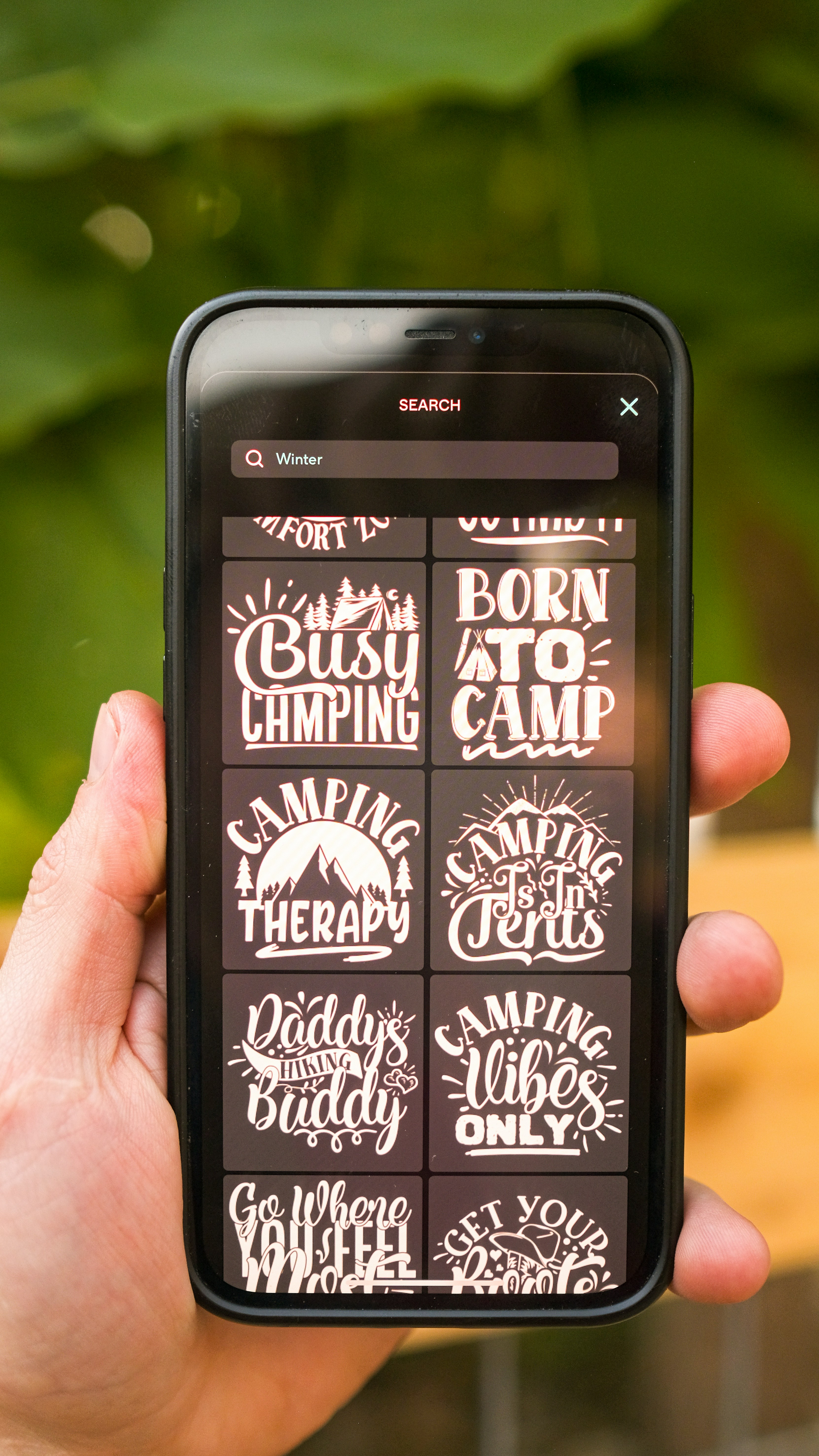 a hand holding a black rectangular device