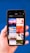 A hand holding a smartphone displaying a search for 'Holiday' with a grid of images. The images include a boat on water at sunset, a red abstract holiday theme, ocean waves, a Christmas tree design, beach chairs, a camera with travel accessories, festive lights, and holiday greenery on a blue background.