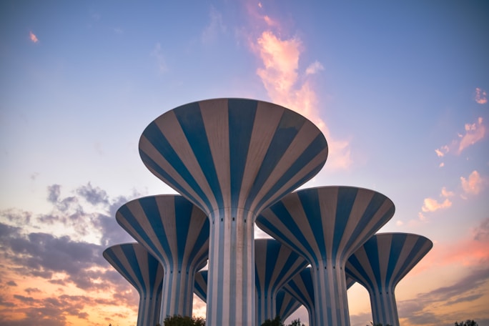 a large white structure with a blue sky and clouds
