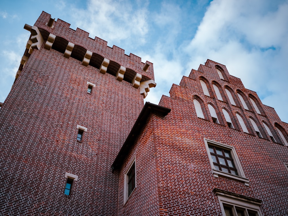 a large brick tower with a clock on the side of a building