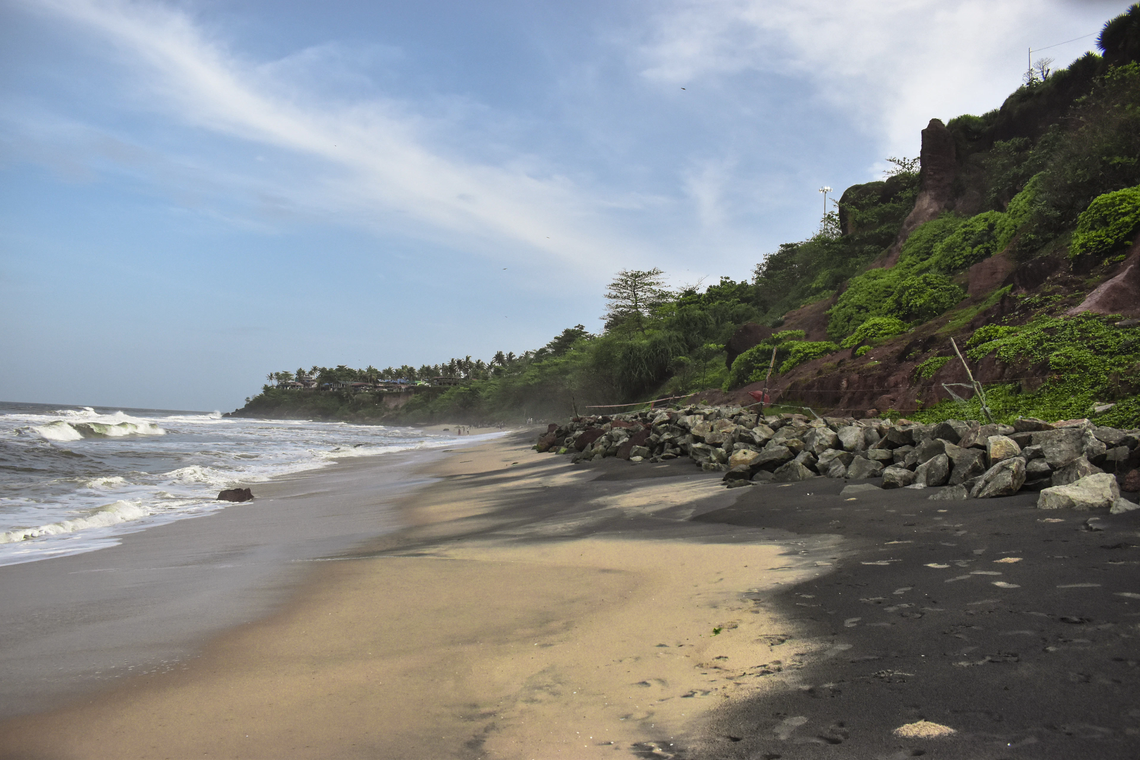 Varkala's dramatic red cliffs meeting the Arabian Sea