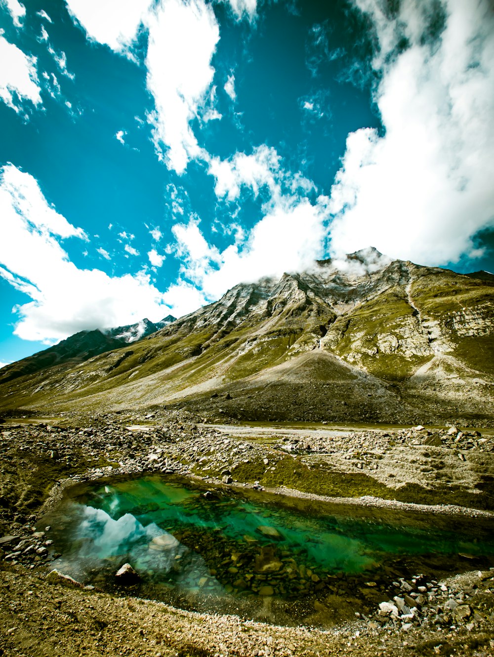 a mountain with a body of water in front of it