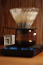 Shotsync timers displayed on a rustic wooden table alongside fresh coffee beans.