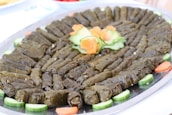 A beautifully plated dish of Armenian tolma garnished with herbs and spices.