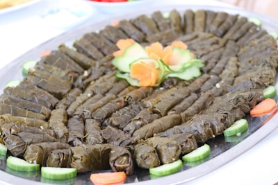 A beautifully arranged tray of stuffed grape leaves and tabbouleh salad.