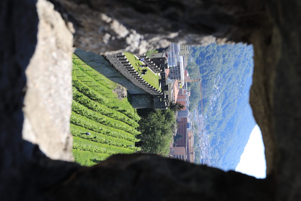 a view of a city from a stone archway