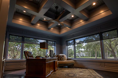 a room with a desk and chairs