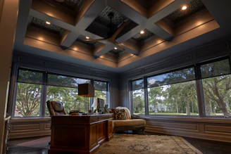 a room with a desk and chairs