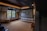 A cozy living room with a large screen displaying a movie in progress.
