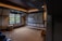 A cozy living room with a family enjoying a movie night on a large screen.
