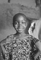 Smiling faces of children holding handmade crafts from a foundation workshop