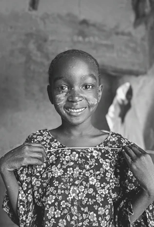 A joyful child holding a handmade drawing, beaming with hope.