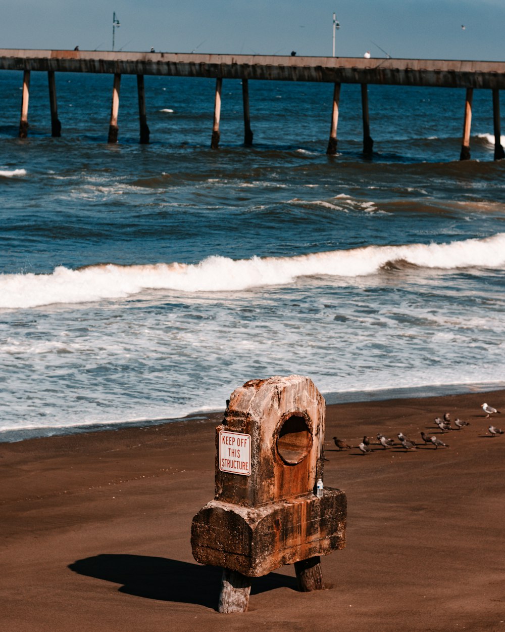 a wooden post on a beach