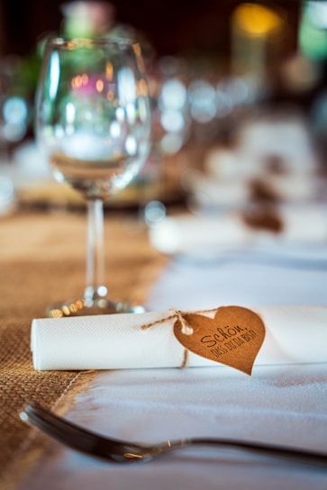 a glass of wine and napkin on a table