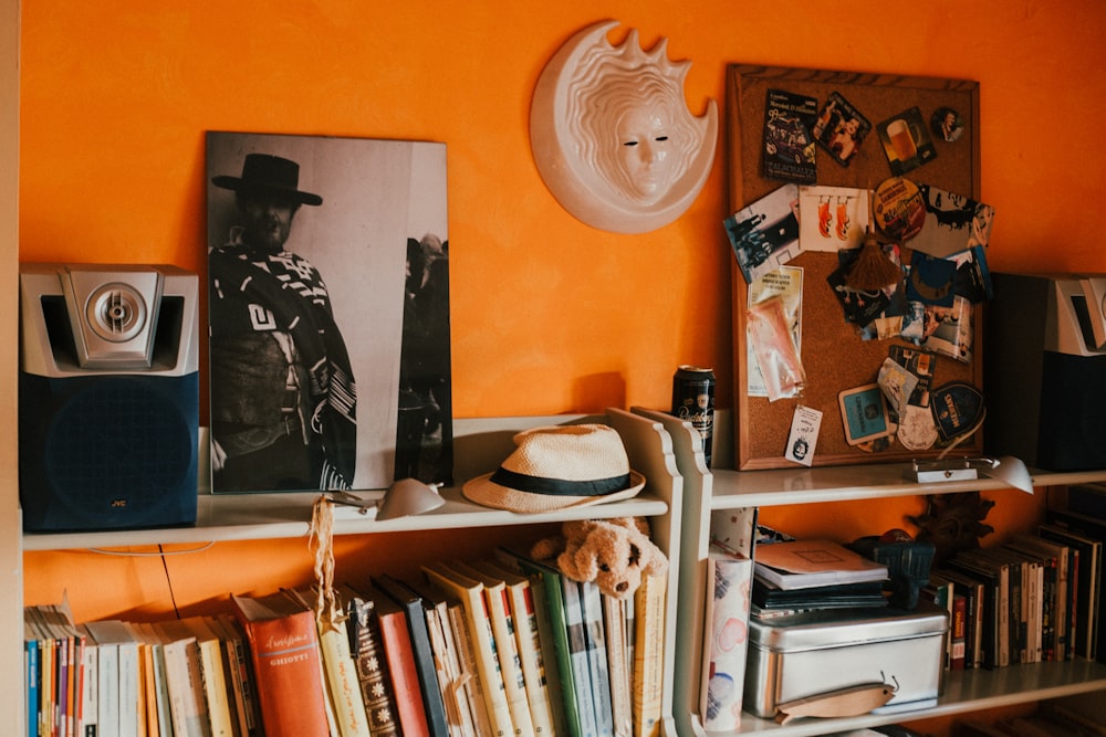 a shelf with books and a hat