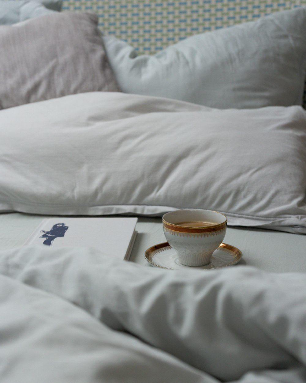 a cup of coffee on a bed