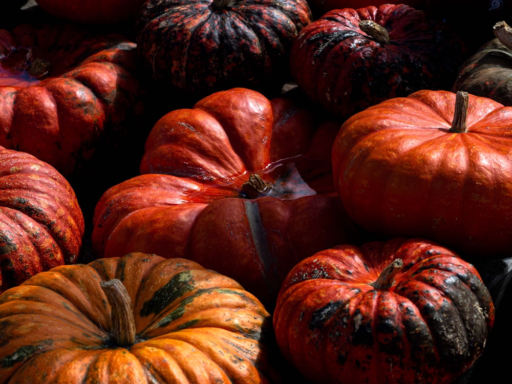 a pile of red and yellow pumpkins