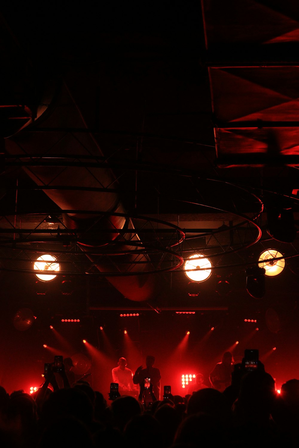 a band on stage with a crowd watching