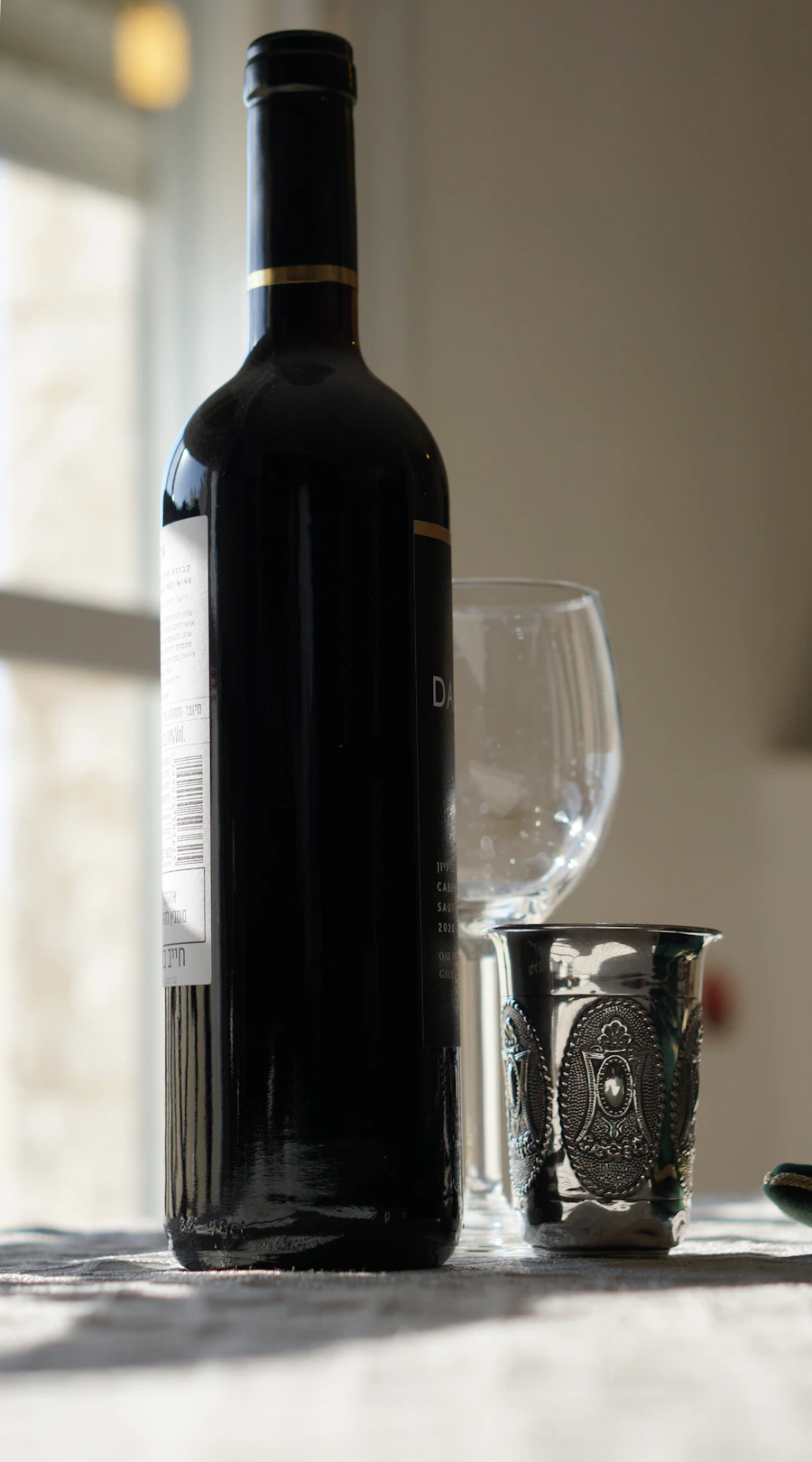 Bottle of wine beside a filled wine glass