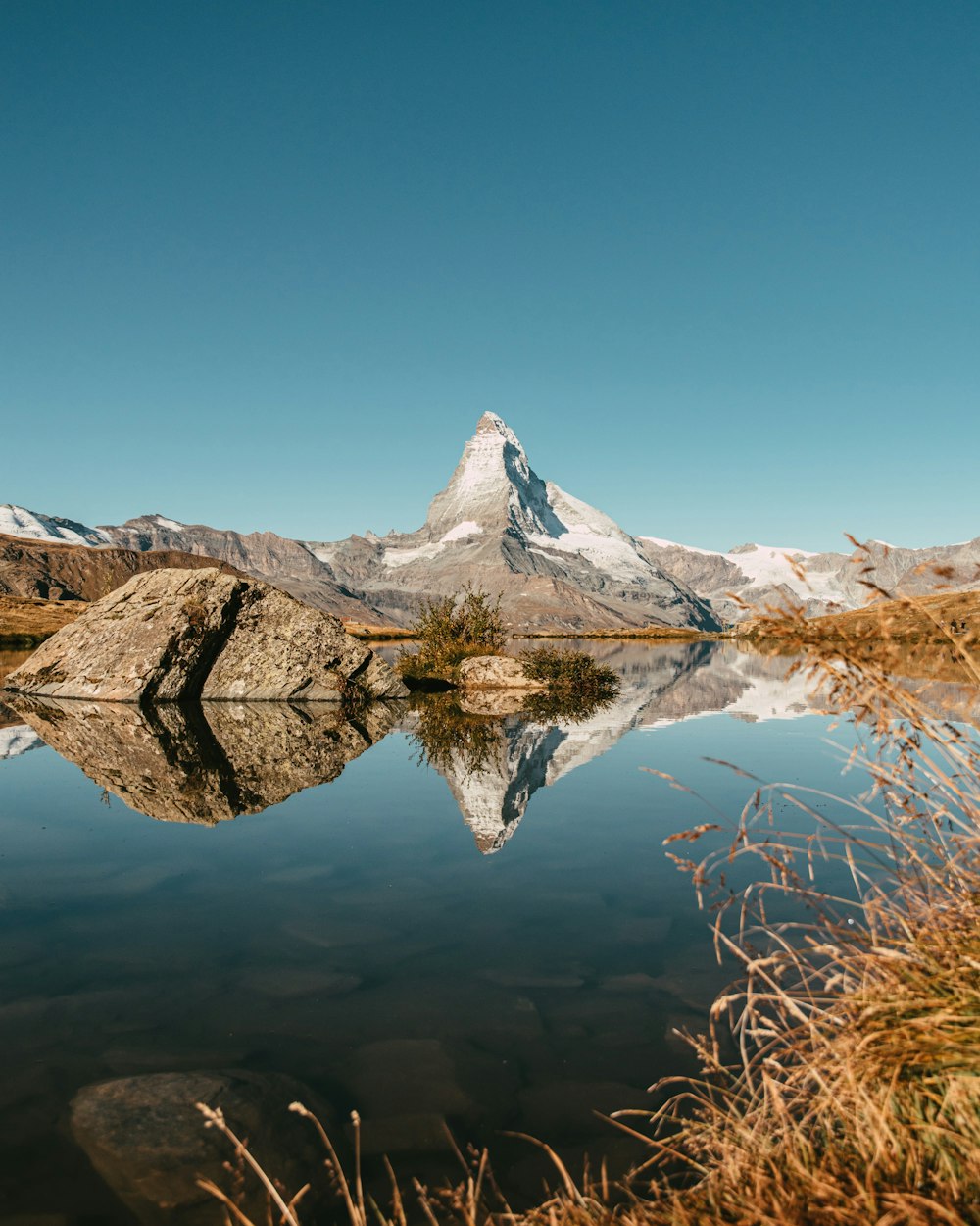 a mountain with a reflection of a mountain in the water