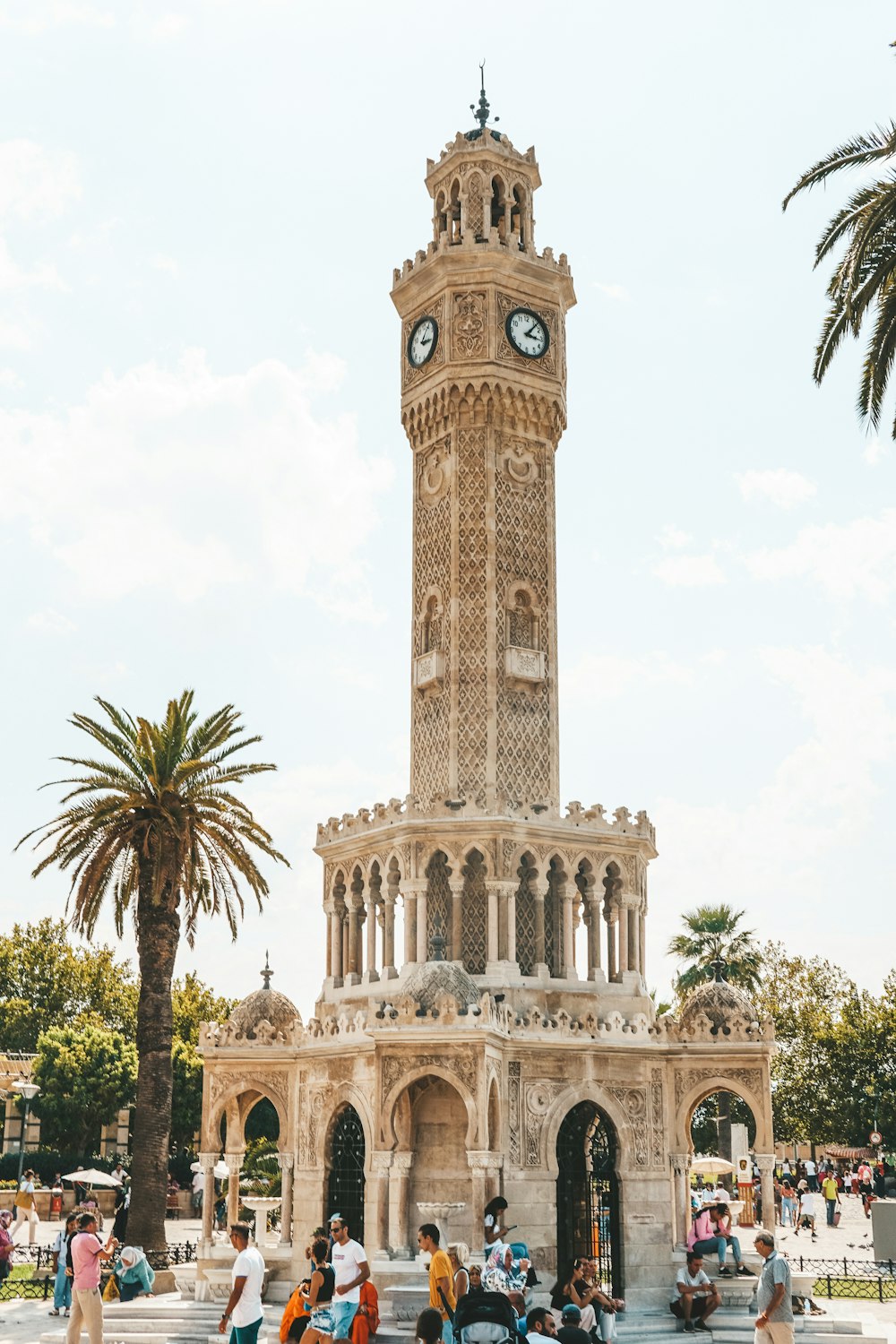 a large clock tower stands tall with İzmir Clock Tower in the background
