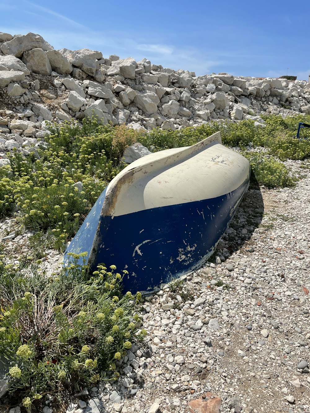 a blue rectangular object on a rocky surface