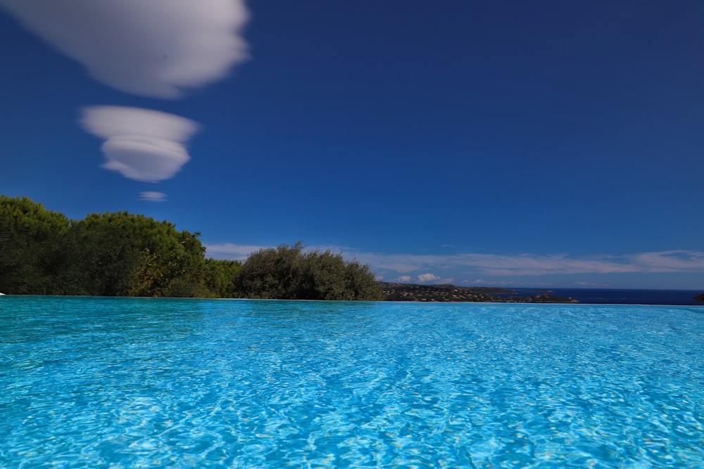 a body of water with trees on the side