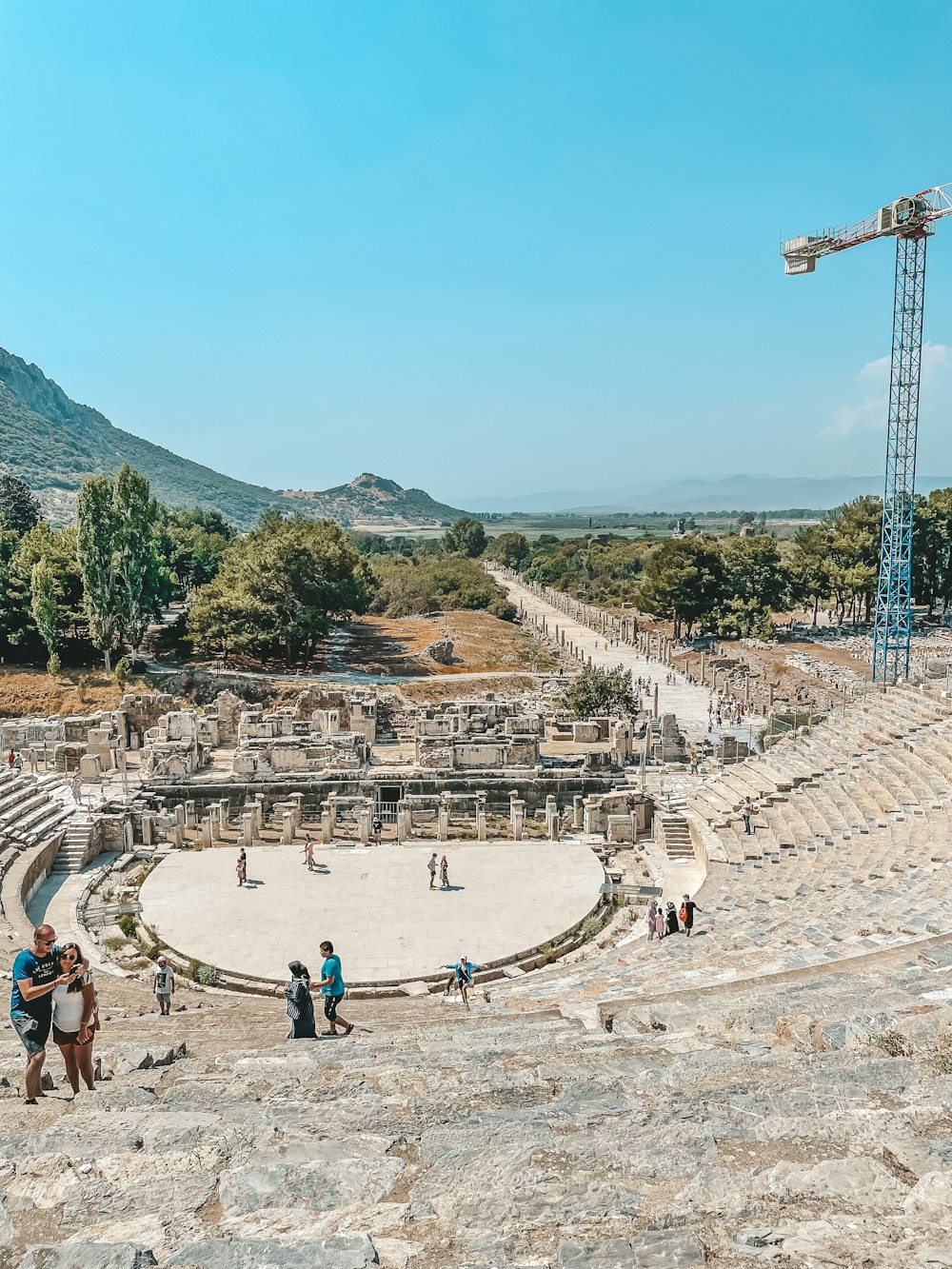 a group of people standing around a large stone structure