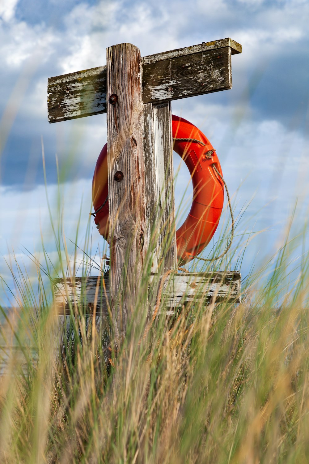 a wooden cross in a grassy field