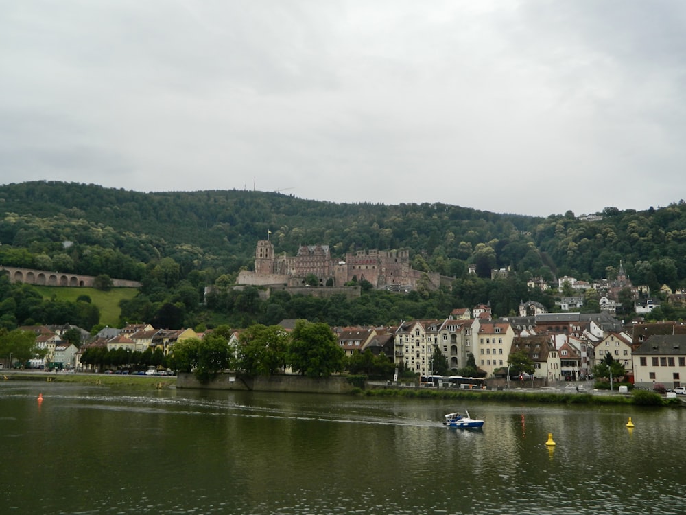 a body of water with buildings and trees around it