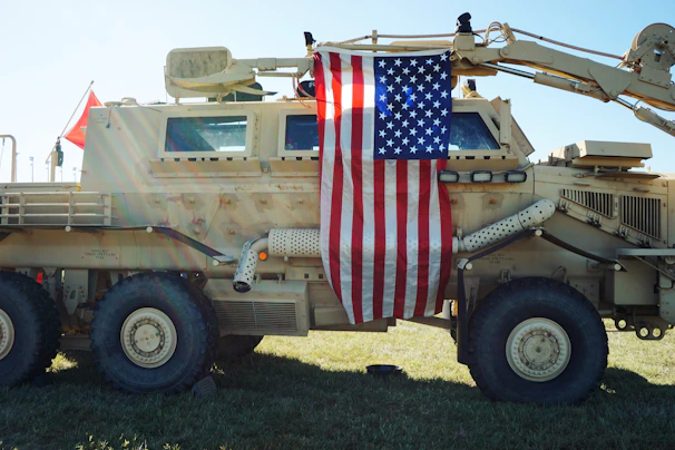 a military vehicle with a flag on the back