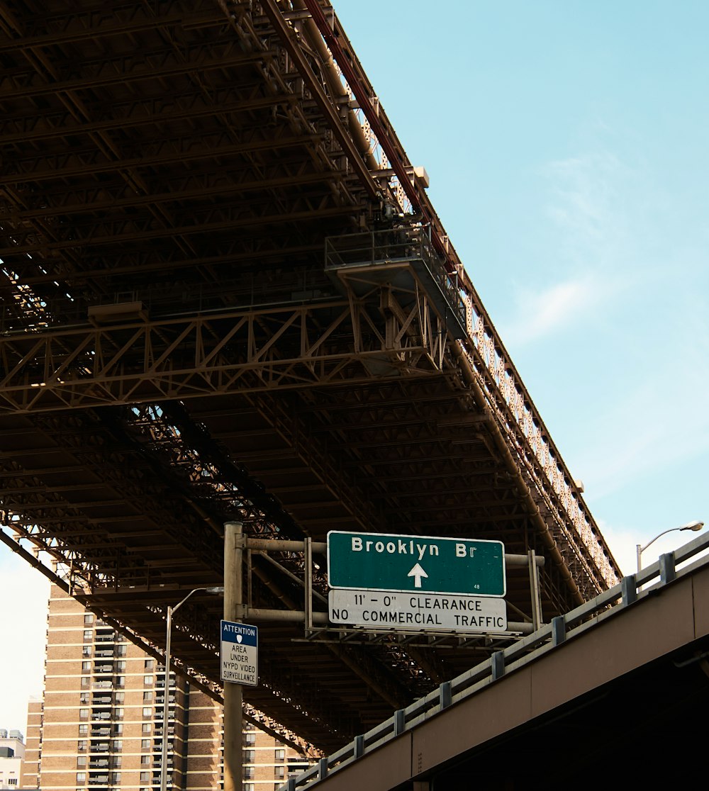 a street sign under a bridge