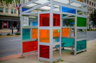 A bustling bus stop wrapped in colorful advertising.